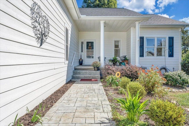 view of exterior entry featuring covered porch