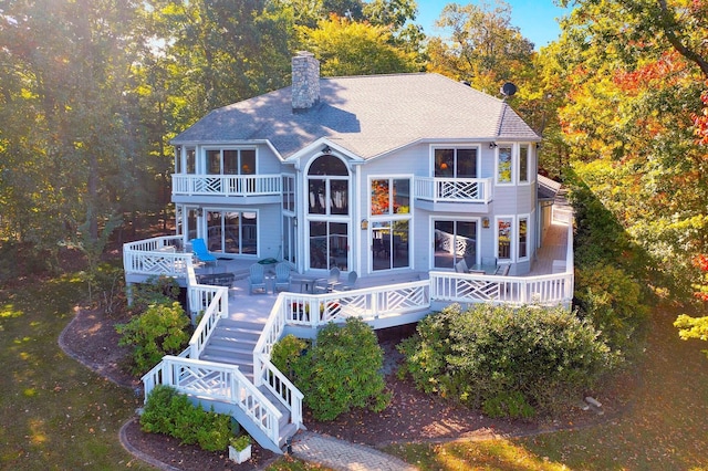 back of property with a balcony