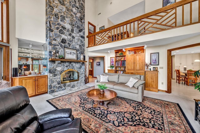 carpeted living room featuring a fireplace and a high ceiling