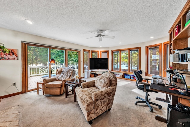 living room featuring light carpet, a textured ceiling, and ceiling fan