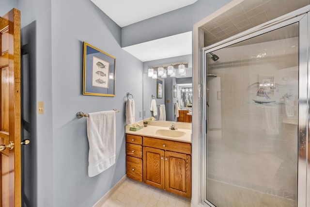 bathroom featuring a shower with door, vanity, and tile patterned floors