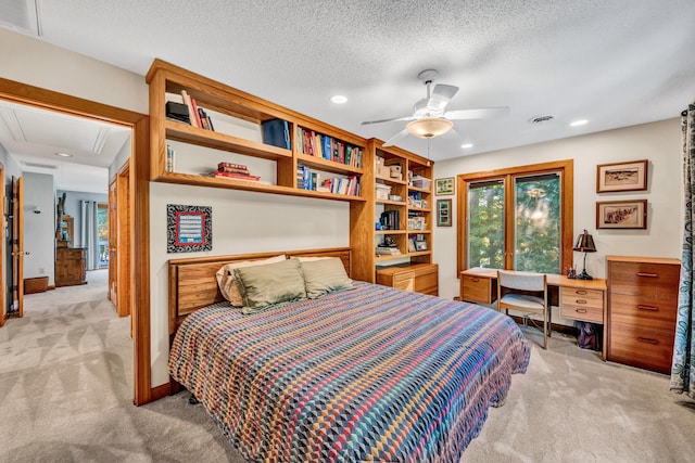 carpeted bedroom with a textured ceiling and ceiling fan