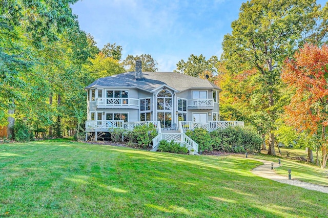 back of house featuring a yard and a deck