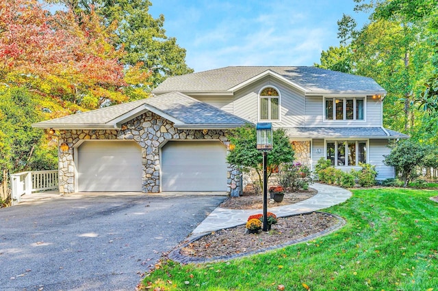 view of property featuring a front lawn and a garage