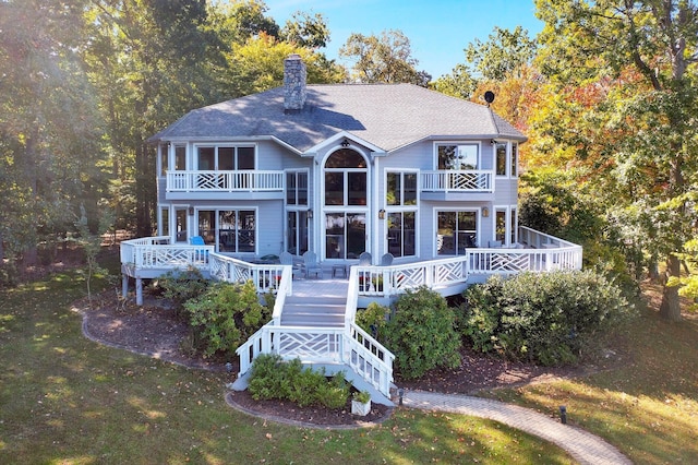 back of house with a deck and a balcony