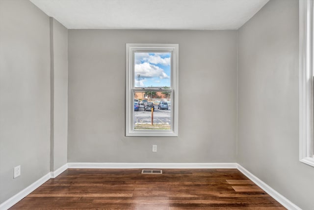 spare room featuring dark hardwood / wood-style flooring