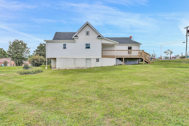 rear view of property with a yard and a deck