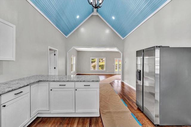 kitchen featuring stainless steel fridge with ice dispenser, white cabinetry, high vaulted ceiling, and wooden ceiling