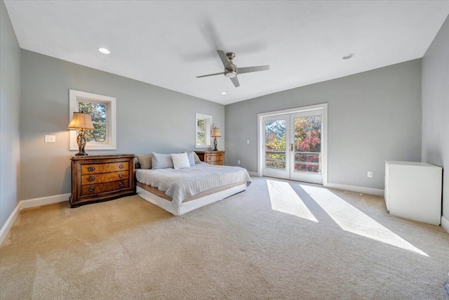 carpeted bedroom featuring access to exterior, ceiling fan, and french doors