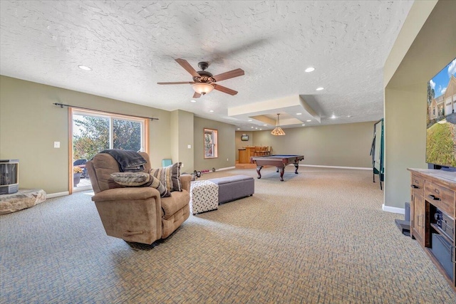 carpeted living room with ceiling fan, pool table, and a textured ceiling