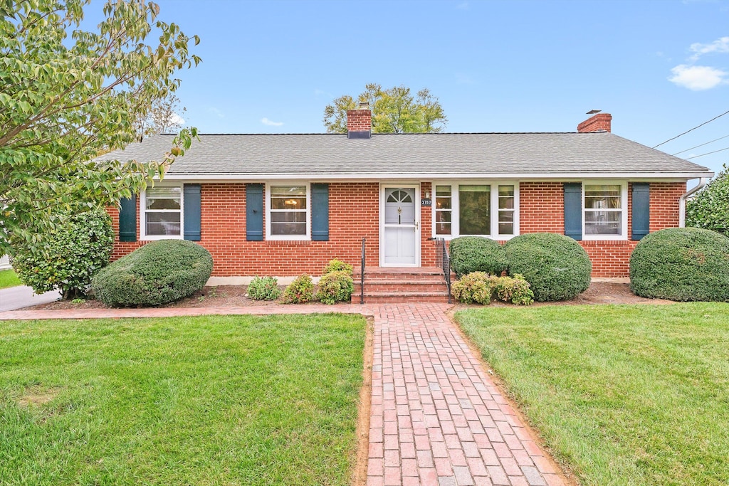 ranch-style house with a front lawn