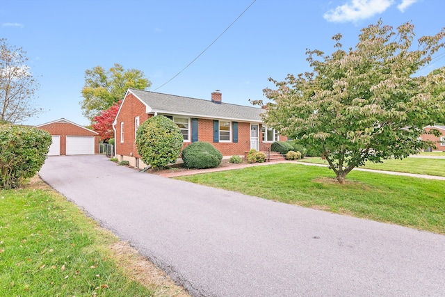 view of front of home featuring a front lawn, an outbuilding, and a garage