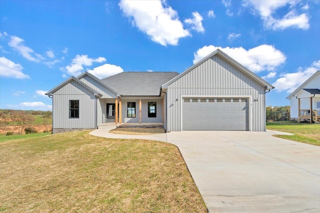 modern farmhouse style home with a front lawn and a garage