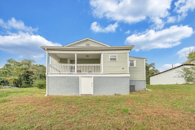 back of property featuring a lawn