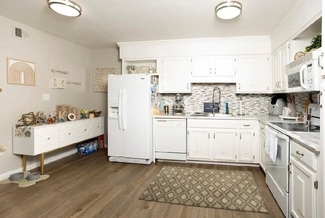 kitchen featuring decorative backsplash, white cabinets, dark hardwood / wood-style flooring, sink, and white appliances