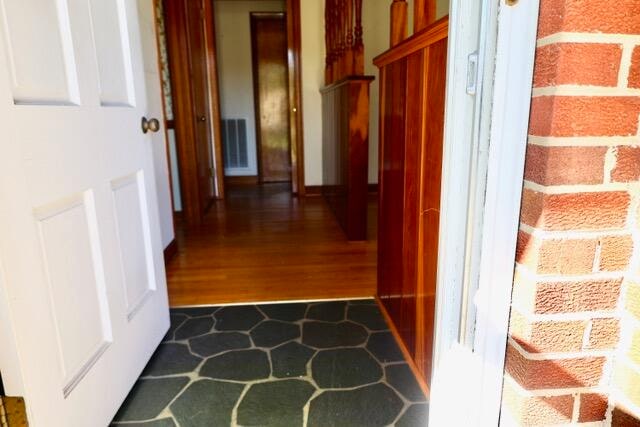 corridor with dark hardwood / wood-style floors