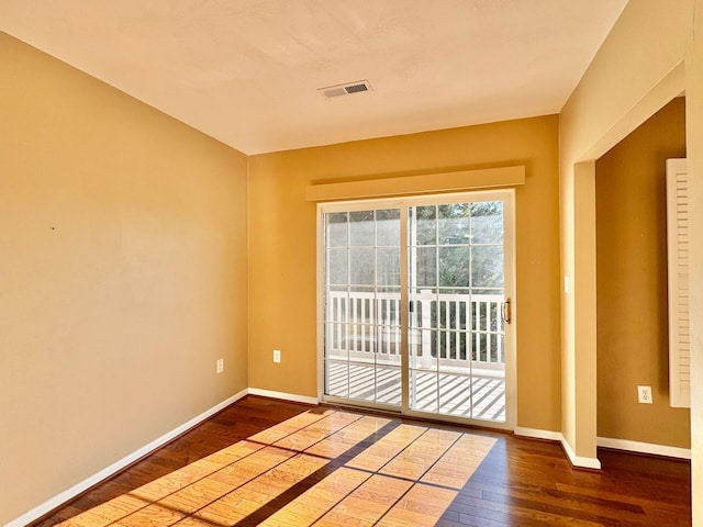 unfurnished room with wood-type flooring