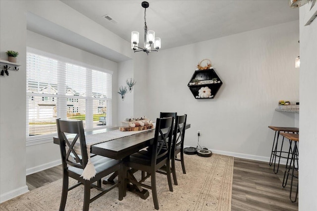 dining space with an inviting chandelier and wood-type flooring