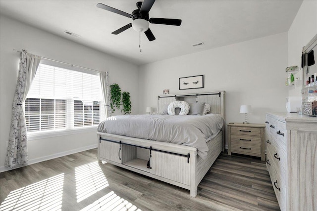 bedroom with dark wood-type flooring and ceiling fan