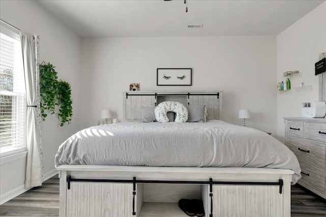 bedroom with dark hardwood / wood-style floors