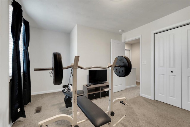 exercise room with light colored carpet