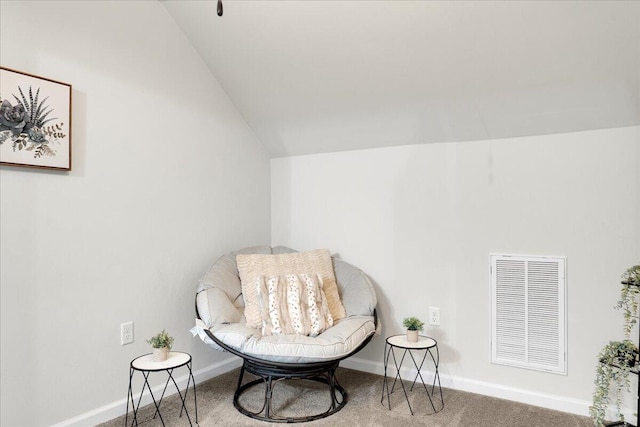 living area with vaulted ceiling and carpet flooring