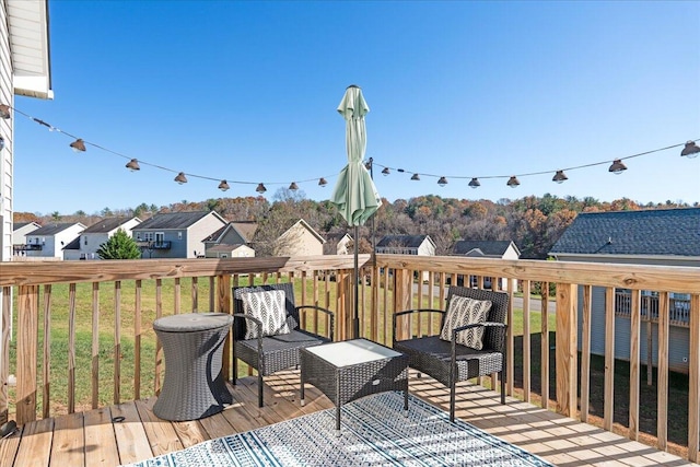 wooden deck with a lawn