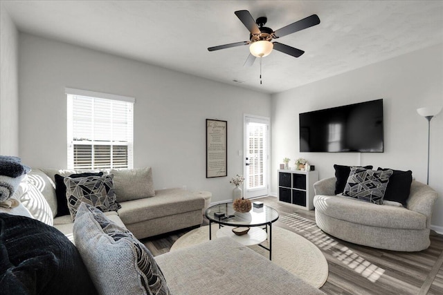 living room featuring a wealth of natural light, hardwood / wood-style flooring, and ceiling fan