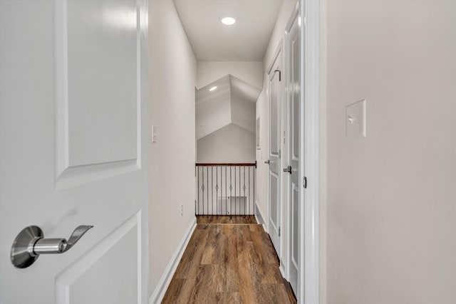 corridor with wood finished floors and baseboards