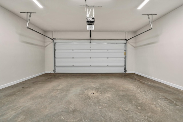 parking deck with baseboards and a garage door opener