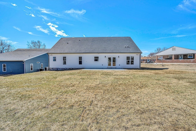 back of property featuring french doors, a patio area, a yard, and roof with shingles