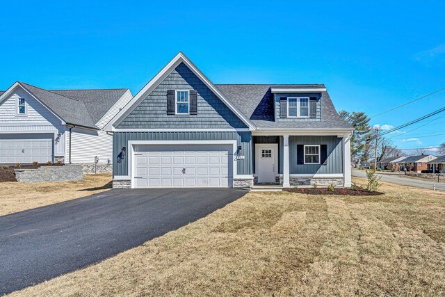 view of front of house with a front yard and a garage