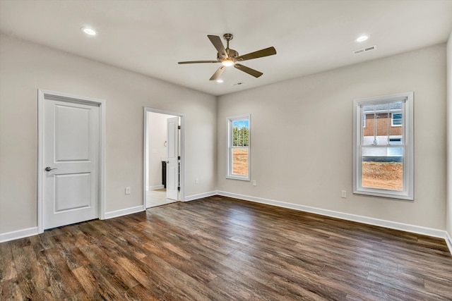 unfurnished bedroom with baseboards, visible vents, dark wood finished floors, and recessed lighting