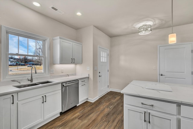 kitchen featuring visible vents, dark wood-style floors, stainless steel dishwasher, pendant lighting, and a sink