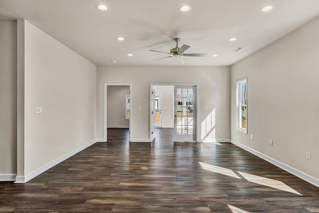 unfurnished room featuring dark wood-style floors, visible vents, baseboards, and recessed lighting