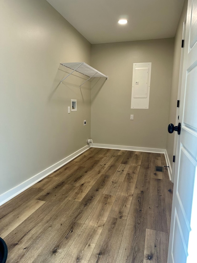 laundry area with hardwood / wood-style flooring, washer hookup, electric panel, and electric dryer hookup