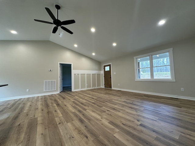 unfurnished living room featuring lofted ceiling, hardwood / wood-style flooring, and ceiling fan