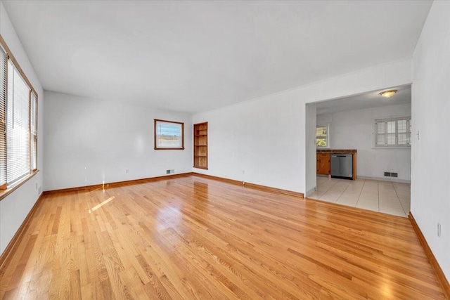 unfurnished room with light wood-type flooring