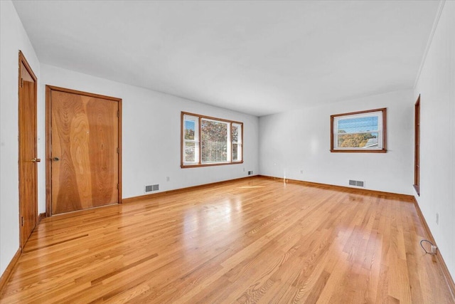 empty room with light hardwood / wood-style flooring