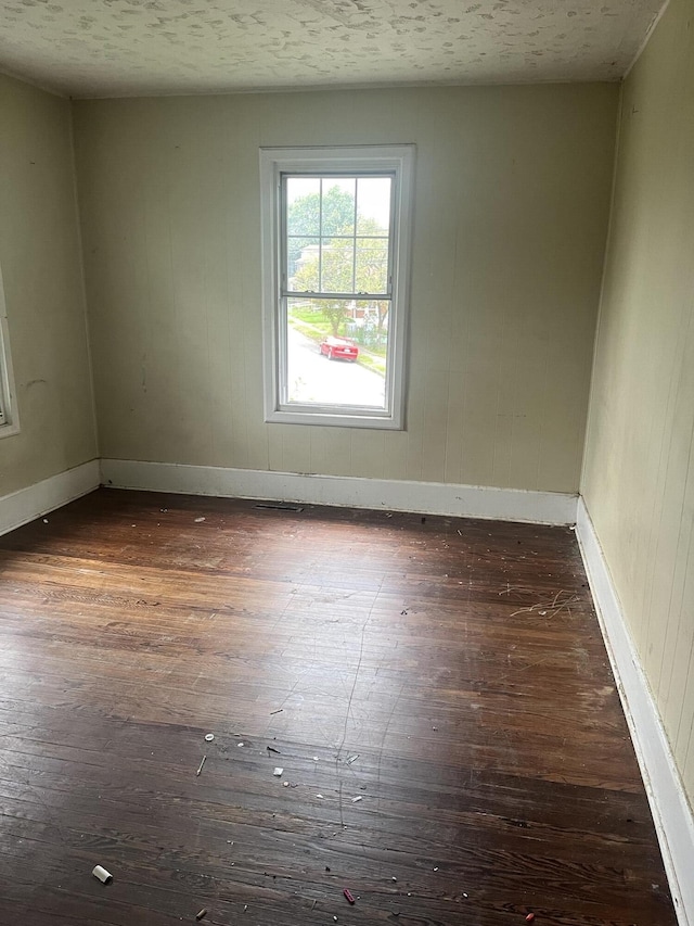 802 Morrill Ave SE, Roanoke, VA 24013 - empty room featuring dark wood-style floors, baseboards, and a textured ceiling