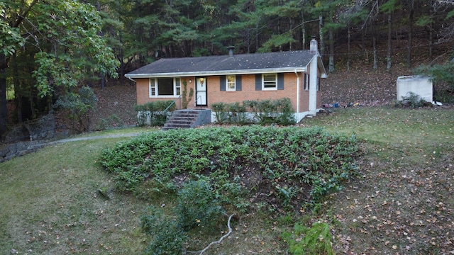 7464 Marie Dr, Roanoke, VA 24018 - ranch-style house with a forest view, a front lawn, brick siding, and central AC