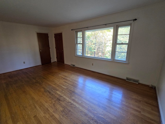 spare room with dark wood-type flooring