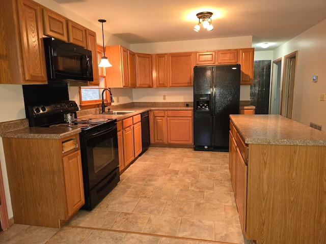 kitchen featuring black appliances, sink, and decorative light fixtures