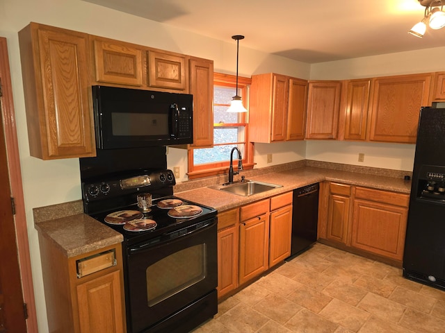 kitchen featuring hanging light fixtures, black appliances, and sink