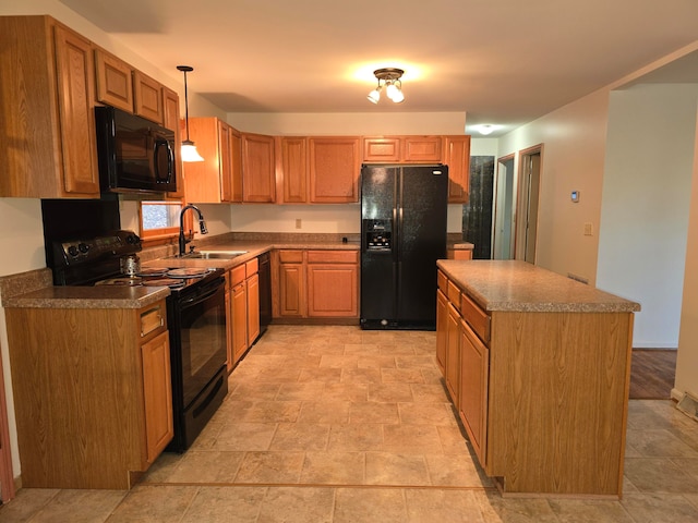 kitchen with sink, black appliances, pendant lighting, and a kitchen island