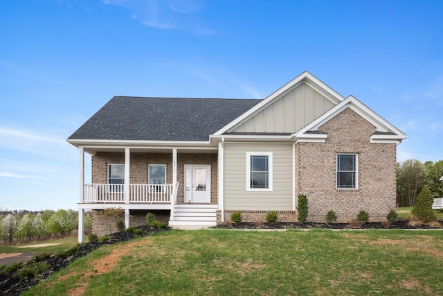 6913 Doral Dr, Radford, VA 24141 - view of front of house with brick siding, a porch, board and batten siding, and a front yard