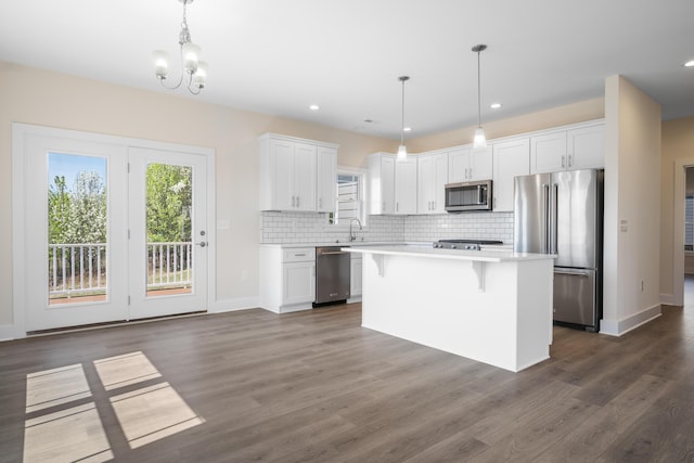 6913 Doral Dr, Radford, VA 24141 - kitchen featuring white cabinets, a sink, tasteful backsplash, light countertops, and appliances with stainless steel finishes