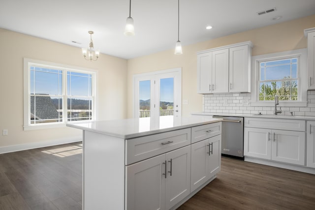 6913 Doral Dr, Radford, VA 24141 - kitchen featuring dark wood-type flooring, tasteful backsplash, stainless steel dishwasher, and a sink