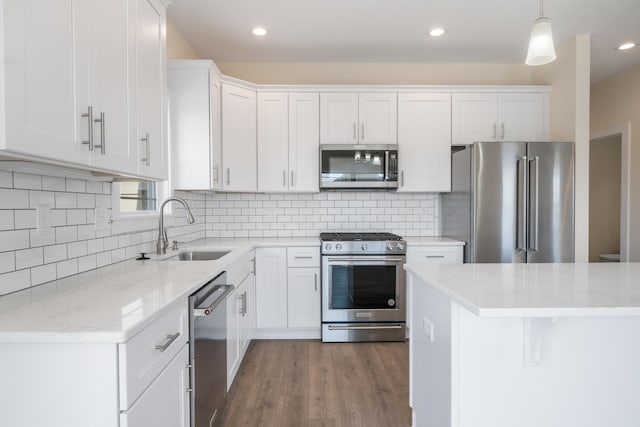 6913 Doral Dr, Radford, VA 24141 - kitchen with white cabinets, appliances with stainless steel finishes, light stone countertops, and a sink