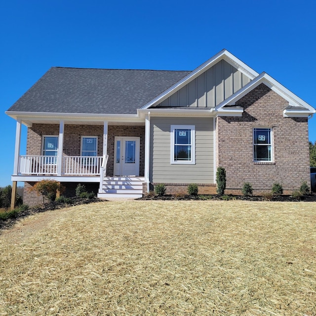 view of front of home featuring covered porch and a front yard